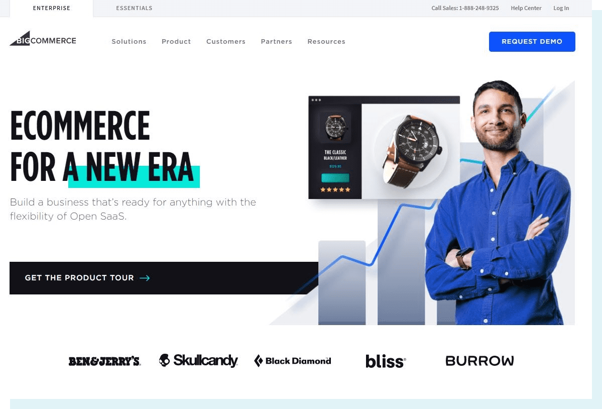 An image of the BigCommerce homepage. The main text reads "Ecommerce for a new era," with brands like Ben & Jerry's, Black Diamond, and Skullcandy featured in bold text. There is a man dressed business casual in front of a blue data chart.