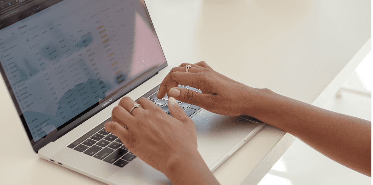Owner store hands typing on wix ecommerce 