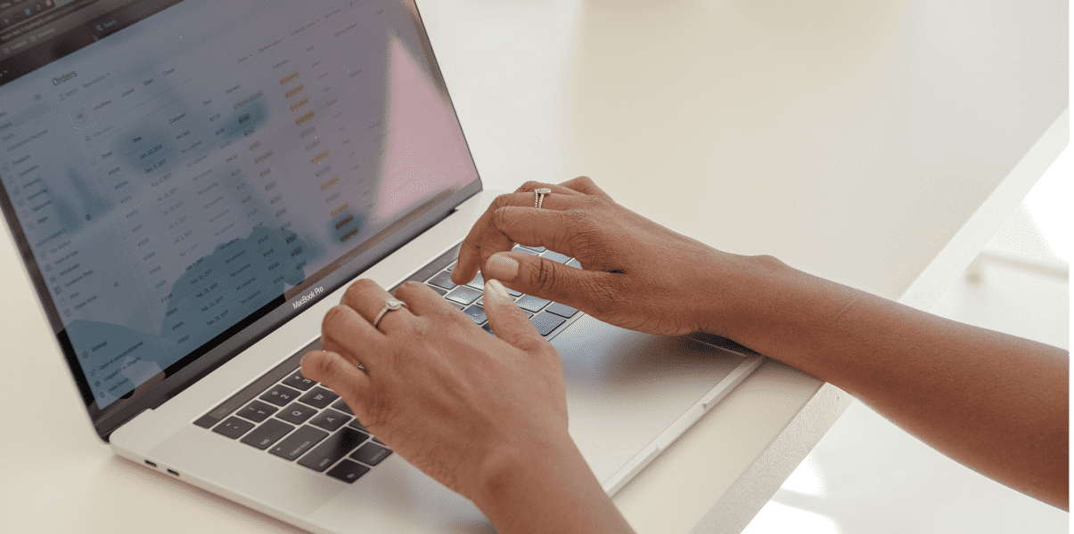Owner store hands typing on wix ecommerce